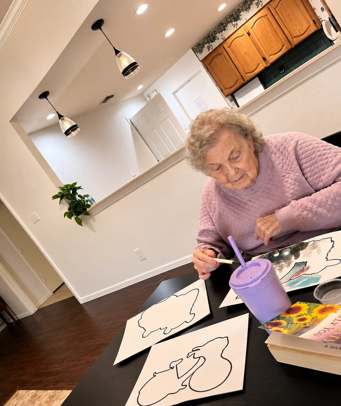 A resident painting at the dining table